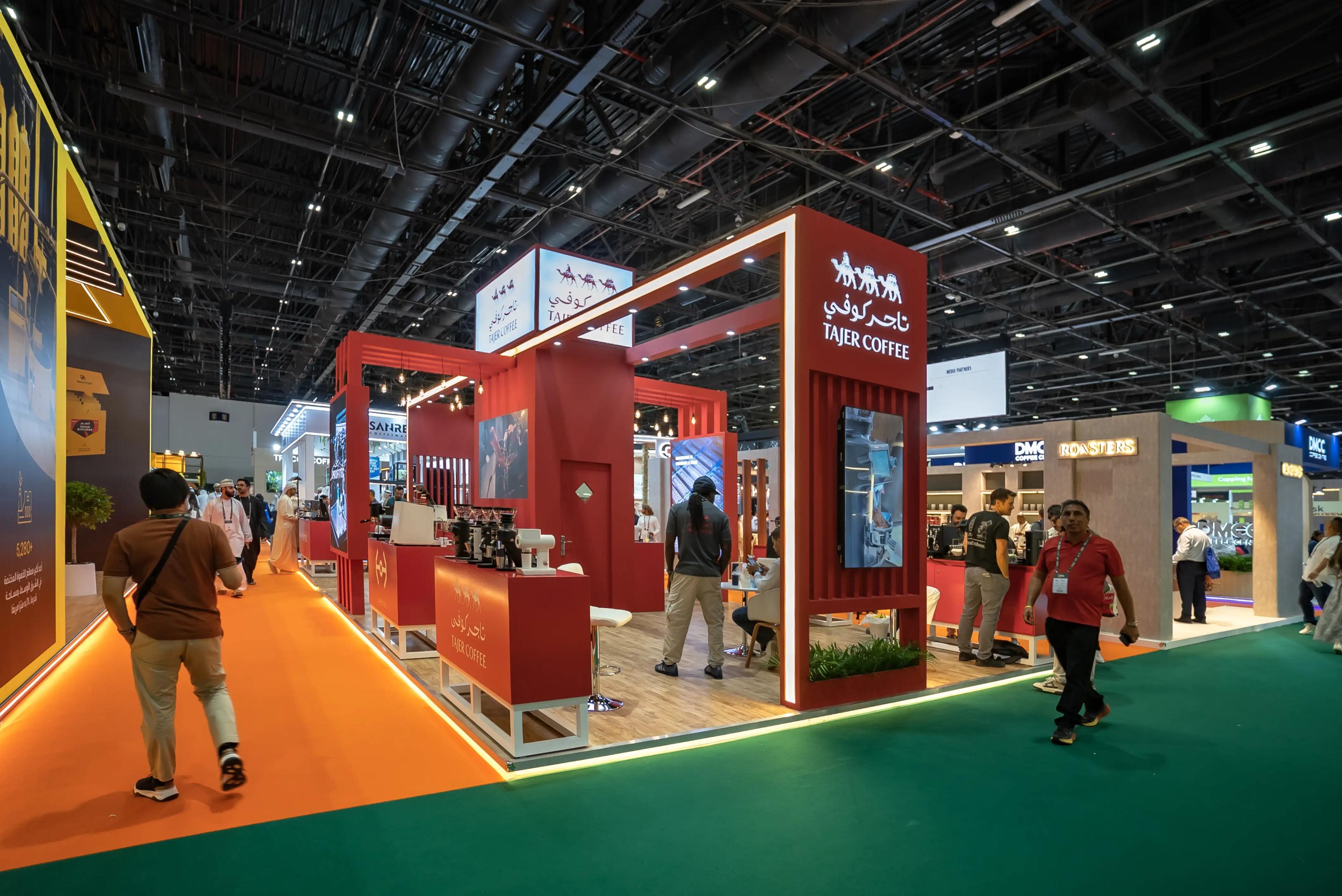 Grand multi-portal exhibition stand with illuminated red architecture